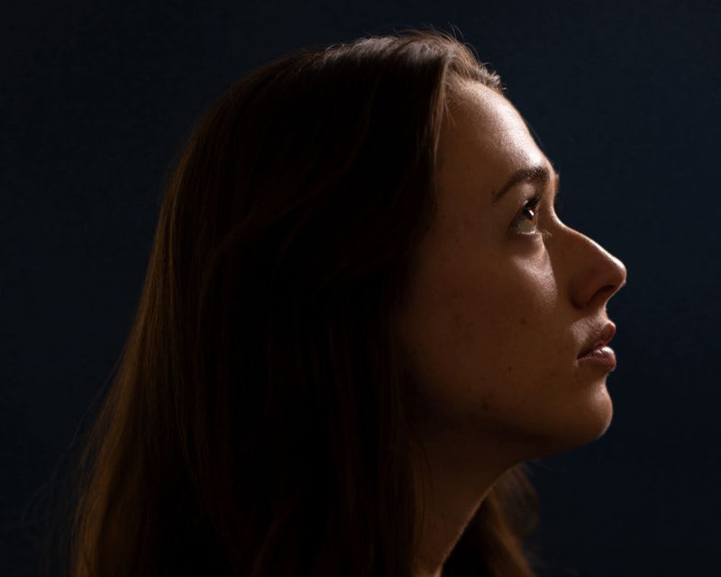 Lume Cube's Cordless Ring Light Pro illuminates a woman's profile for a moody, dramatic portrait