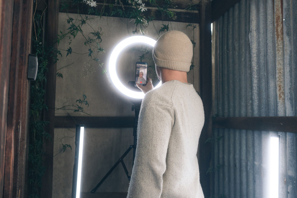 Content creator filming with a Lume Cube ring light