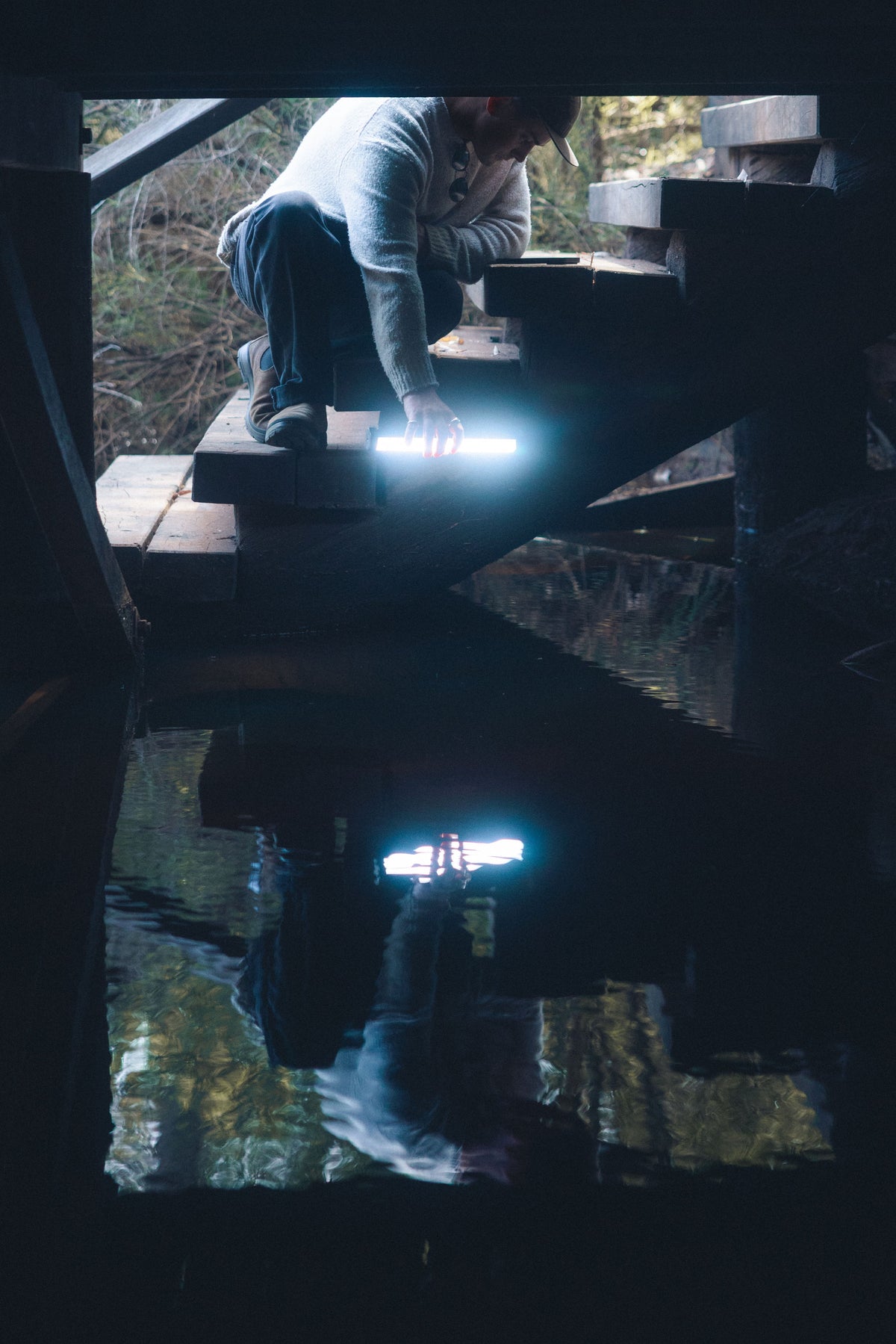 Adventurer carrying a portable Lume Cube light outdoors