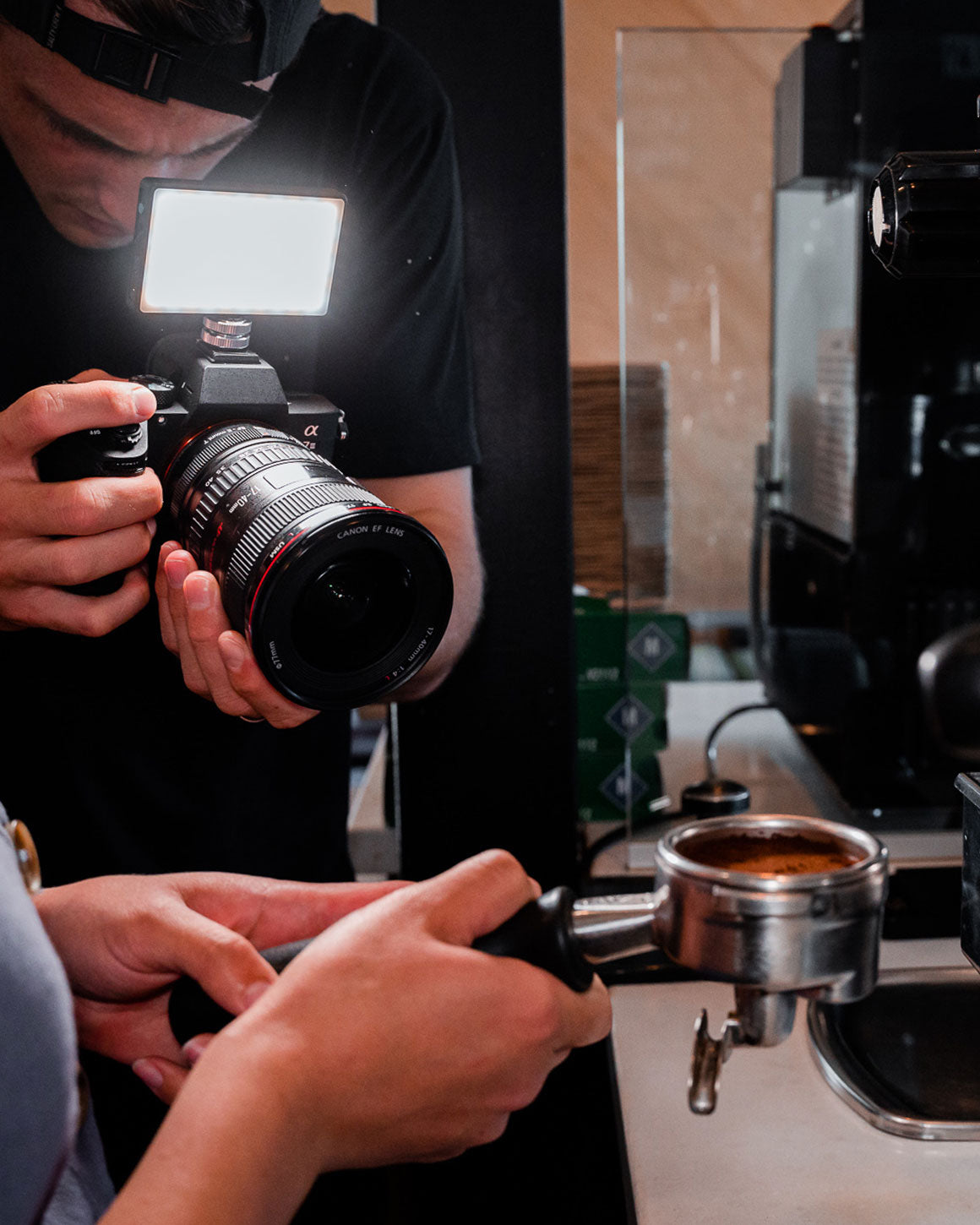 Man taking photos with tiny black metal Lume Cube LED Panel Mini mounted on Sony camera. LC-PANELMINI1
