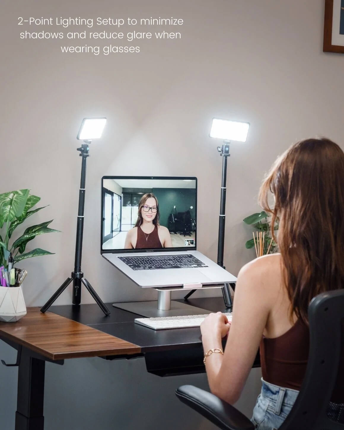 Woman at desk using 2 Lume Cube Broadcast Lighting Kits to remove glare on glasses during video call. LC-SB-DLX