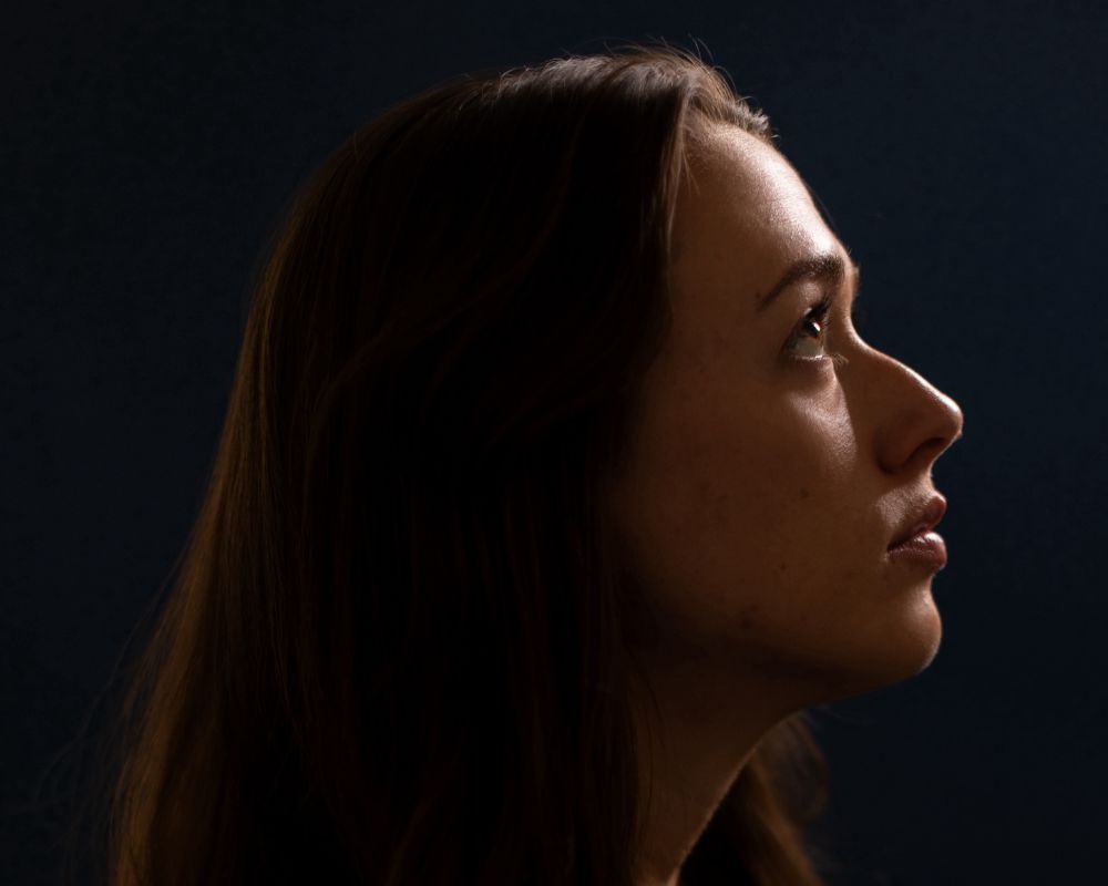 Lume Cube's Cordless Ring Light Pro illuminates a woman's profile for a moody, dramatic portrait