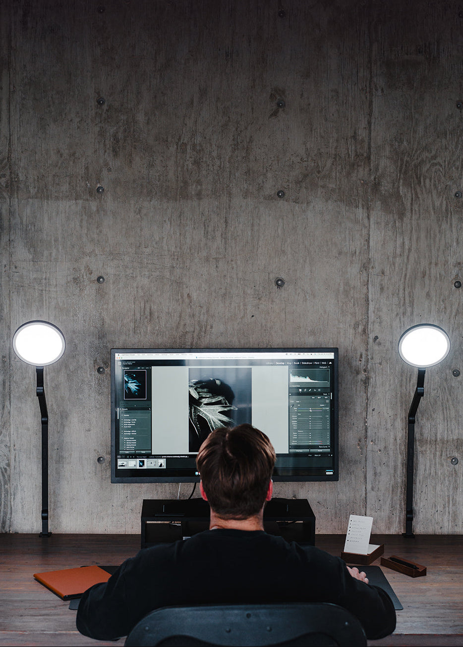 Guy at desk with two lamps
