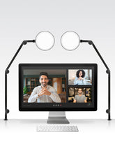 Black Lume Cube Edge Light 2 Pack clamped on white desk illuminating computer monitor and workspace. #color_edge light 2 Pack - black