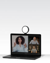 Lume Cube VC-Lite small circular suction-mounted light on Laptop during a video conference call.