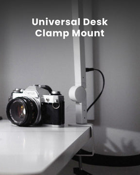 Close up of the Edge Light Desk Clamp with a camera on a desk LC-SB-EDGE2-W-2PACK