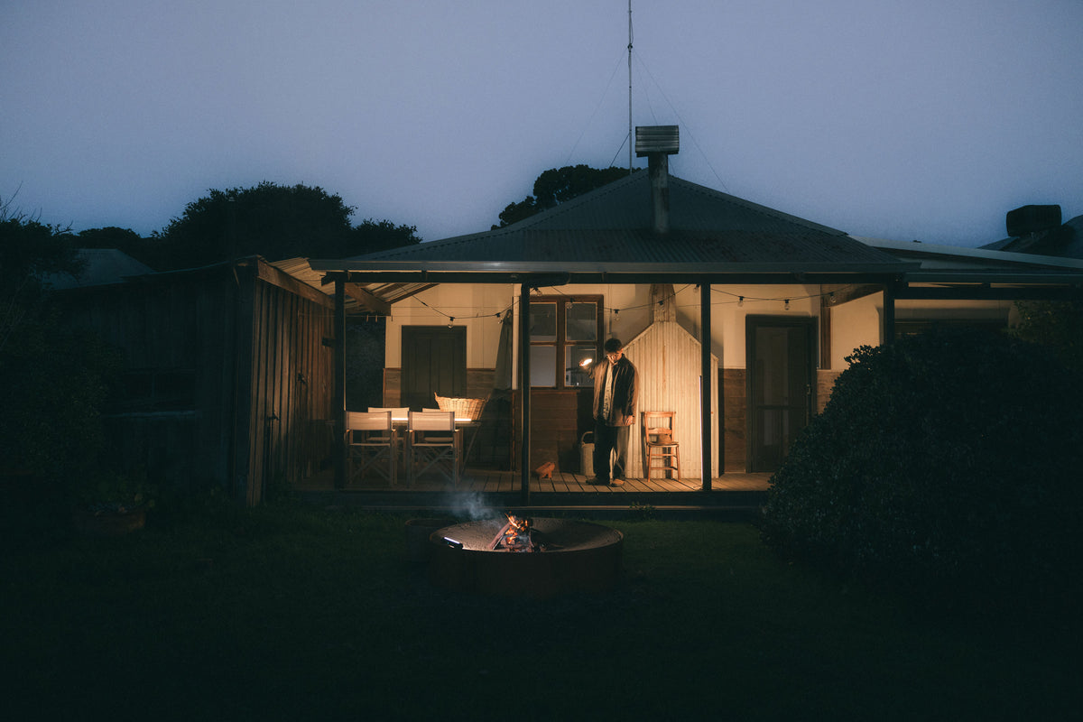 Man holding a Lume Cube RGB Tube Light on his porch at night, a glowing holiday gift idea