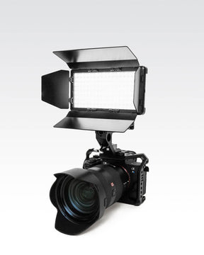 Camera with RGB Panel Pro and black metal 4-slat barn doors mounted on top. LC-SB-PRO2T60ACC