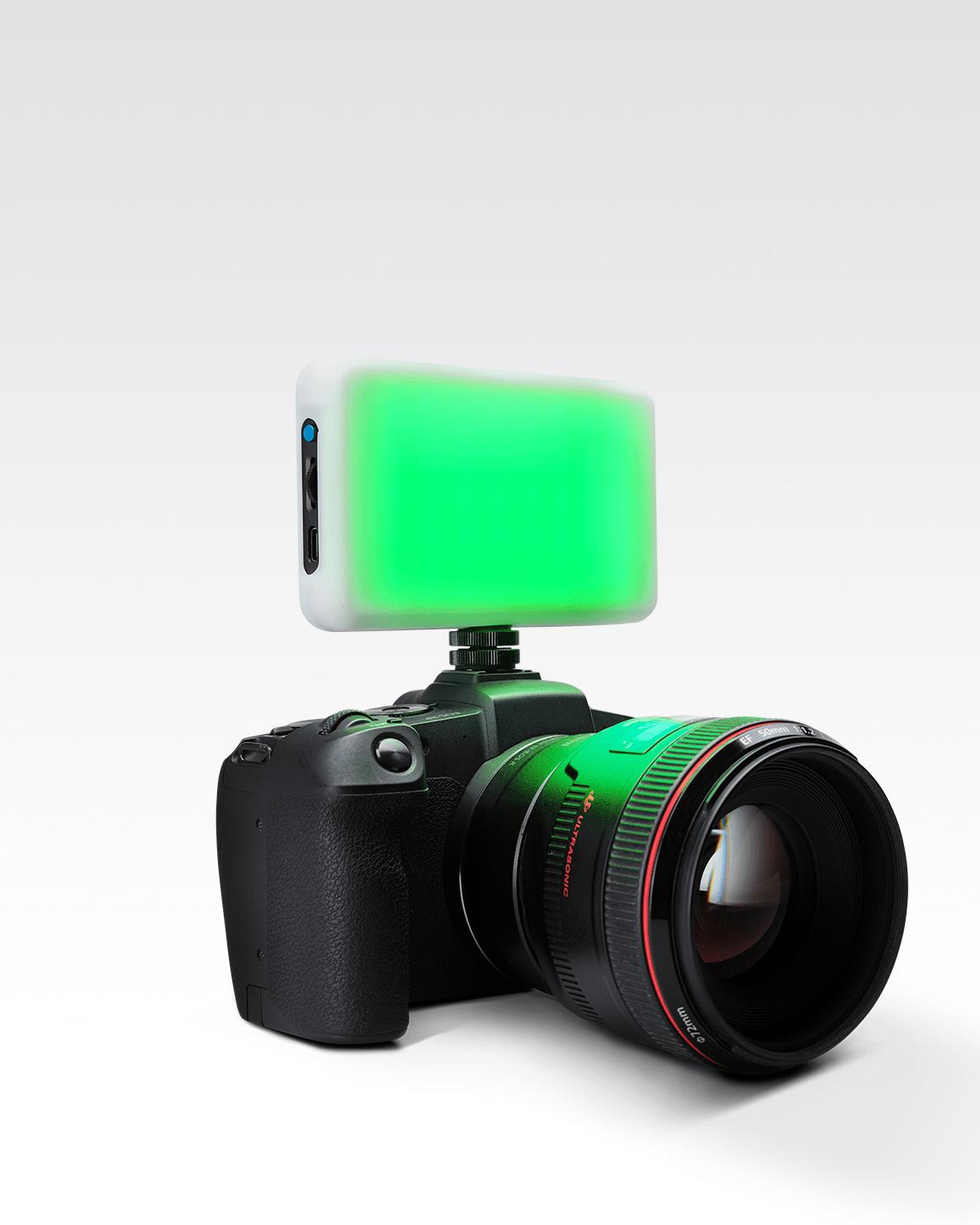Lume Cube RGB Panel Go mounted on Sony camera with Green LEDs glowing behind white Silicone Diffuser sleeve.