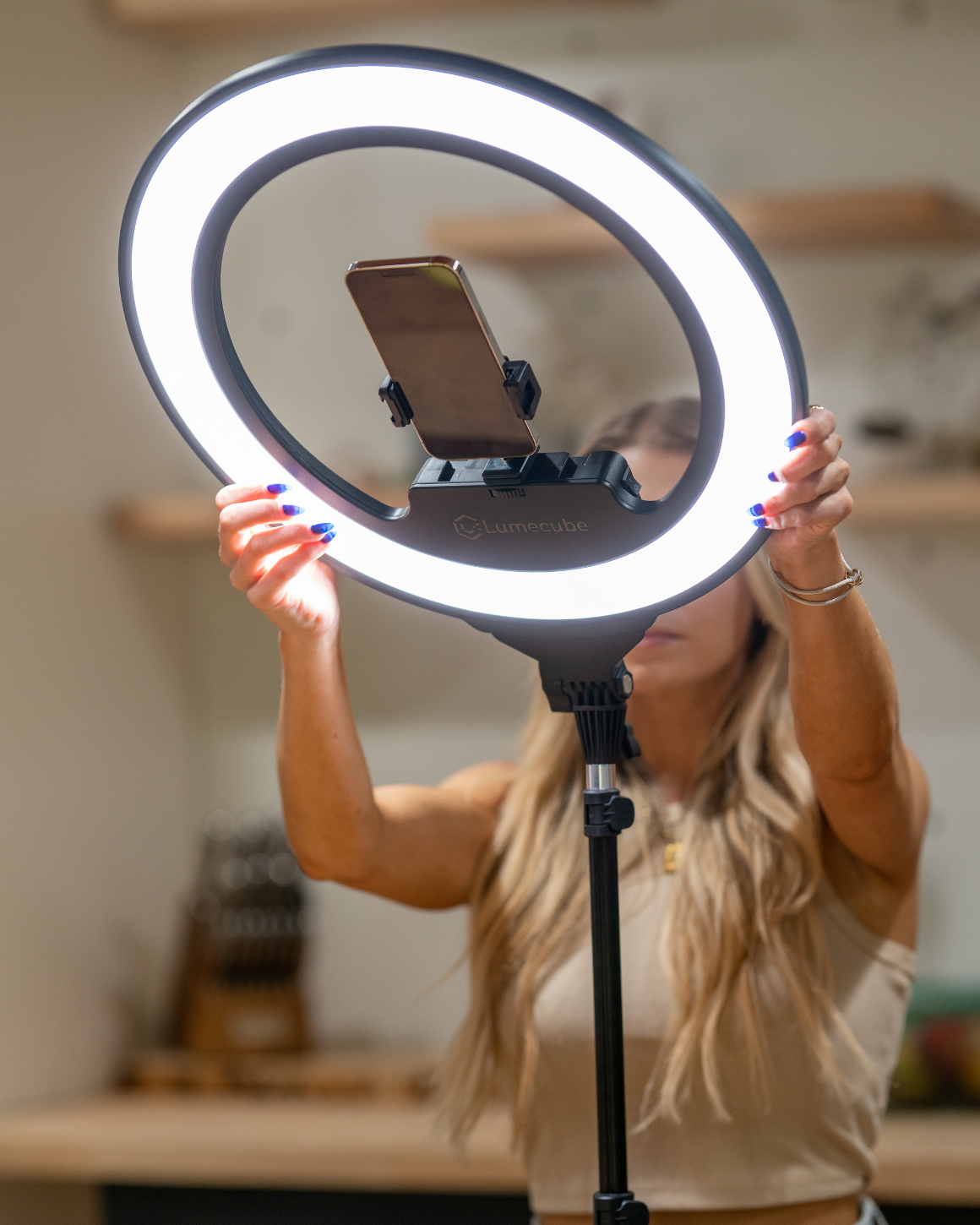 A woman adjusted the angle of a Ring Light Pro LC-RINGPRO-CR