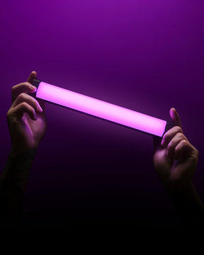 Person holding RGB Tube Light Mini on dark background