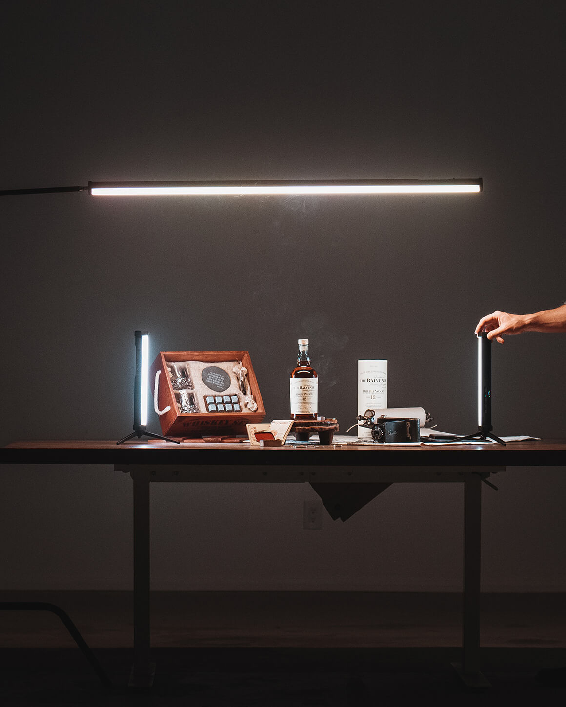RGB Tube Light XL on stand above table with bottles and RGB Tube Light Mini LC-TLXL-2PK