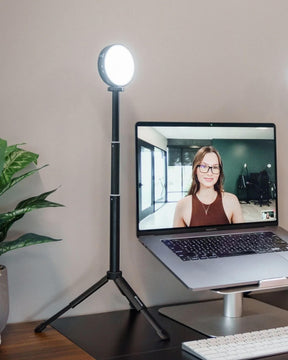 Lume Cube VC-Lite with Stand set up next to a laptop on a riser.