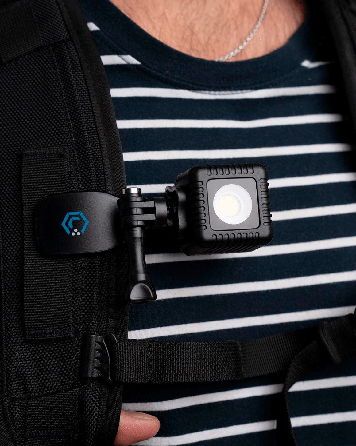 All-Purpose Backpack Clip with a Lume Cube 2.0 Waterproof LED attached and clipped to backpack strap.
