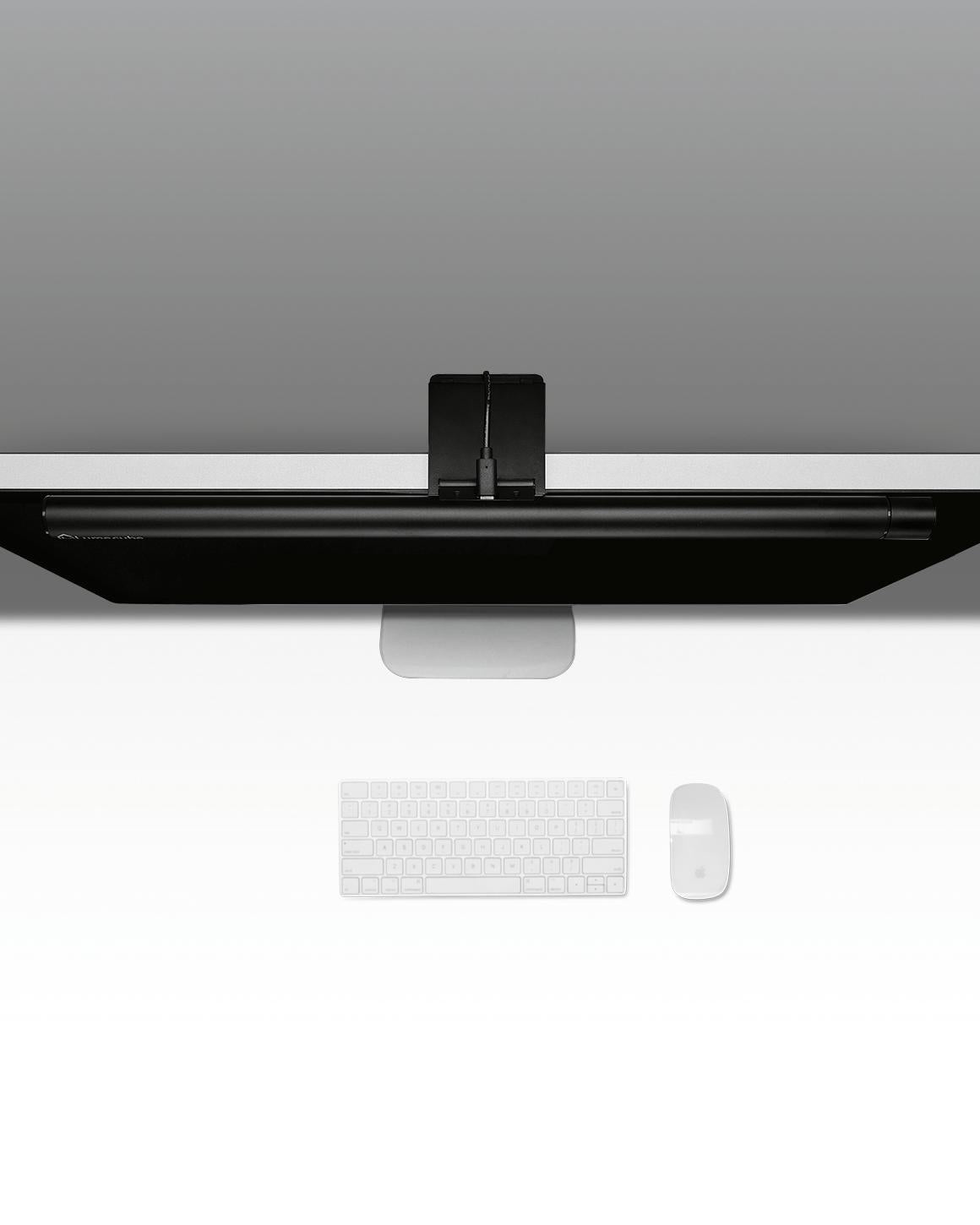 Top-down view of black metal Lume Cube Monitor Light Bar atop Desktop monitor.