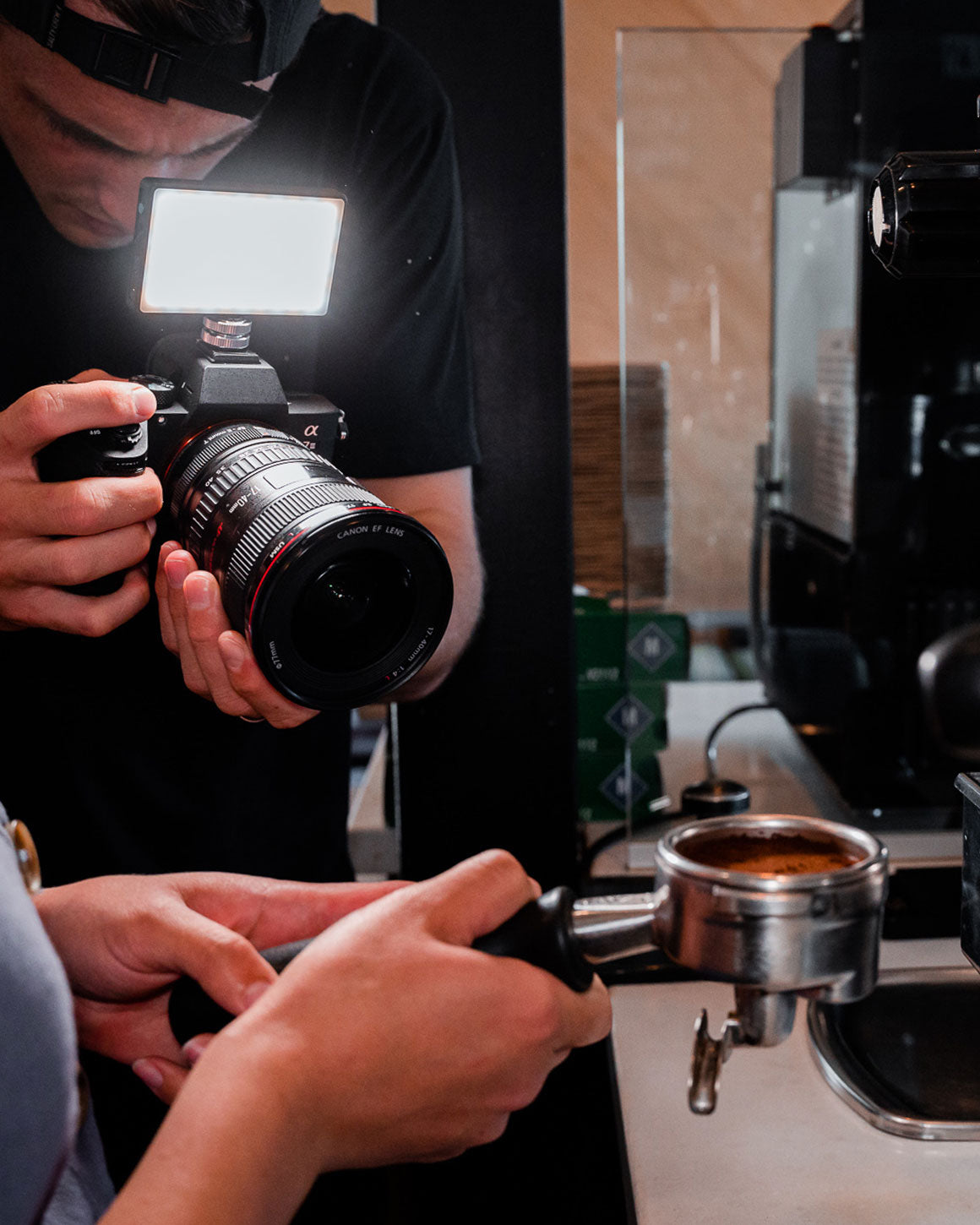 Man taking photos with tiny black metal Lume Cube LED Panel Mini mounted on Sony camera.