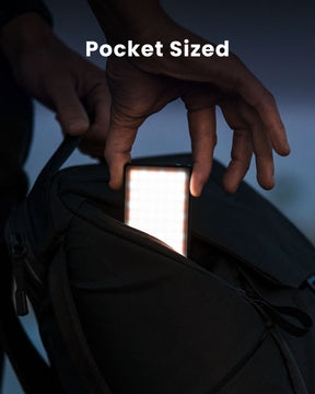 Pocket-Sized. Person slipping credit-card-sized Lume Cube Panel Mini LED into side pocket of backpack to show ultimate portability.