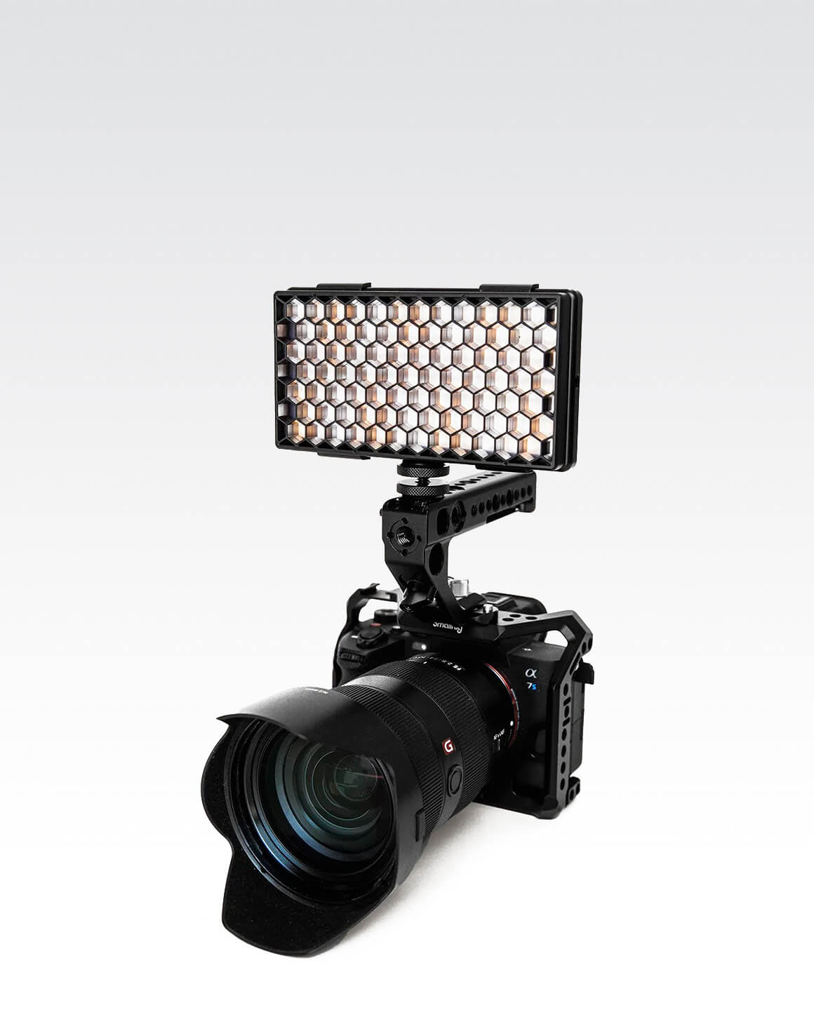 Camera with RGB Panel Pro and black plastic Honeycomb Grid light shaping accessory.