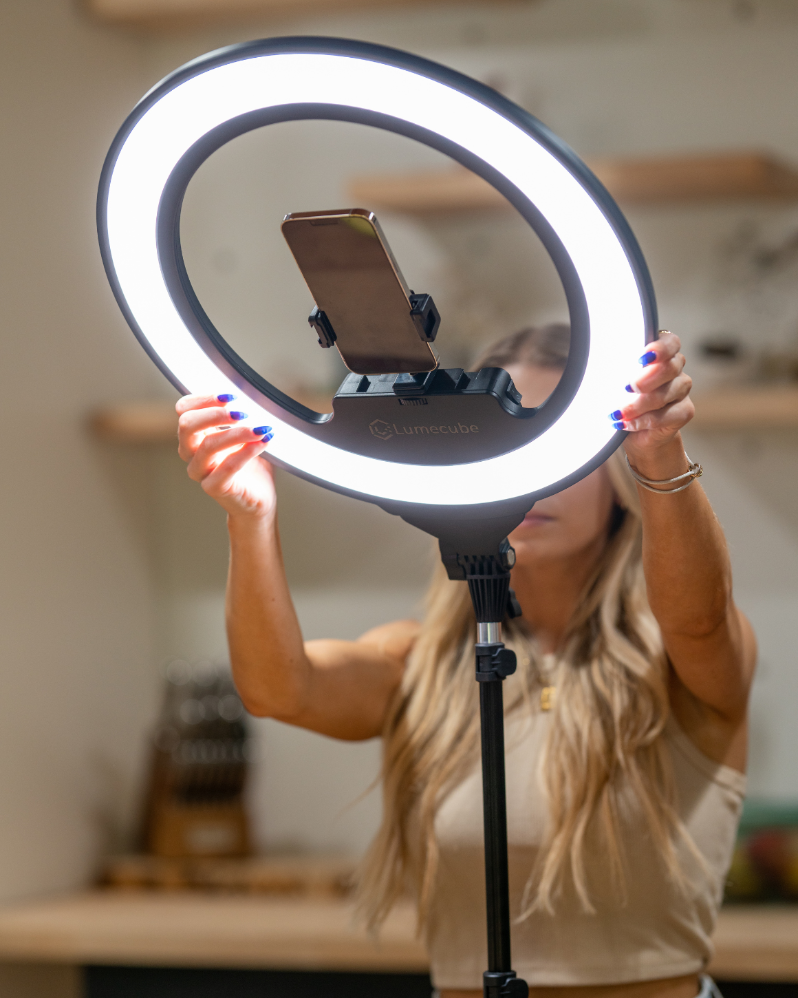 A woman adjusted the angle of a Ring Light Pro