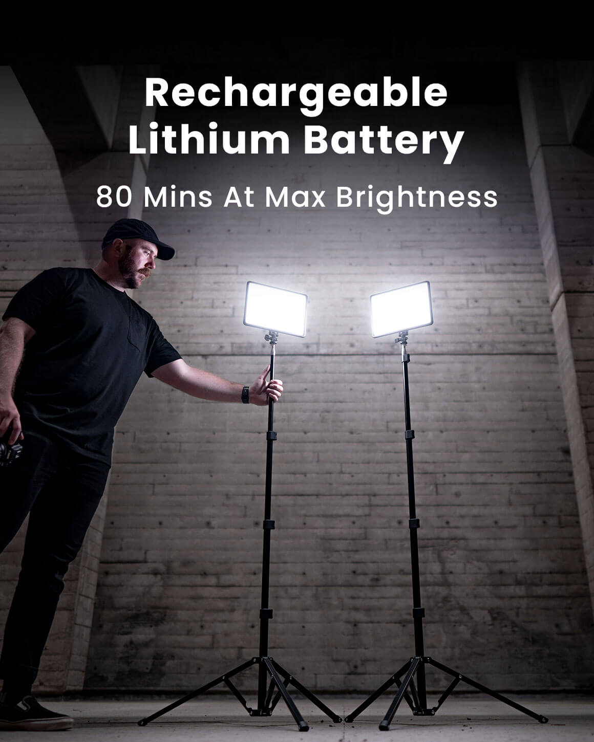 Rechargeable Lithium Battery.  80 minutes at max brightness.  Man standing next to 2 Lume Cube Studio Panels on 70" stands in a dark room.