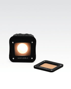 Lume Cube 2.0 Waterproof LED with the Warm Level 4 overlay attached and Warm Level 1 overlay detached.