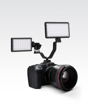 Black metal unique V-shaped Lume Cube Triple Shoe Mount for Multiple Lights & Microphones mounted on DSLR camera with a Panel Mini and a Panel GO attached.